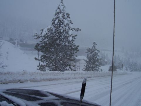 1989 Ford Bronco - A winter scene shows a snow-covered road with trees and a distant overpass.