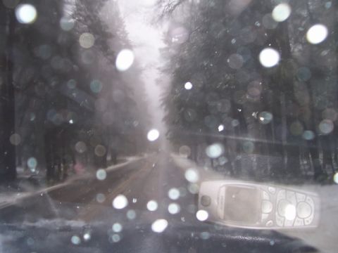 1989 Ford Bronco - Driving through a snowy forest scene, with a cell phone visible on the dashboard.
