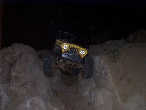 1989 Ford Bronco - This off-road vehicle navigates a rocky terrain in the dark.