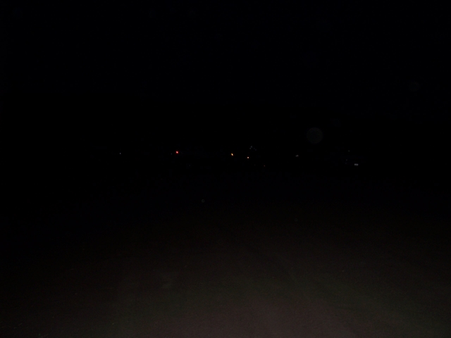 Distant lights visible in a dark night sky