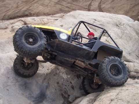 1989 Ford Bronco - This heavily modified buggy navigates a challenging rocky terrain.