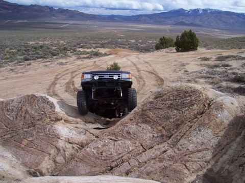1989 Ford Bronco - This 1989 Ford Bronco is navigating a challenging rocky trail in a desert environment.