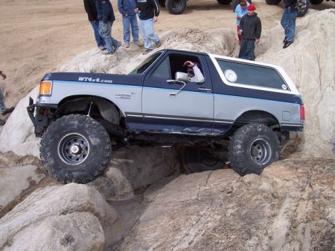 1989 Ford Bronco - This modified Ford Bronco navigates a rocky trail, its off-road capabilities.