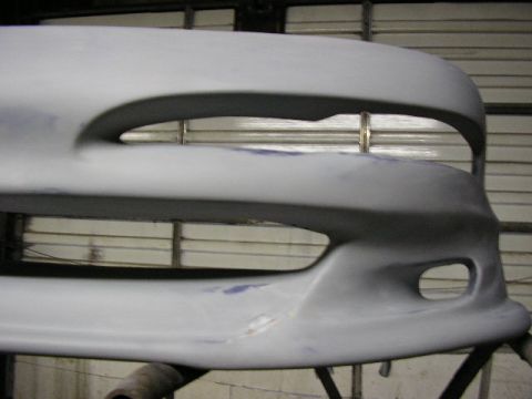 1994 Ford Probe - A car bumper is shown, ready for paint. The "SUPERMOTORS.NET" watermark is visible at the bottom right.