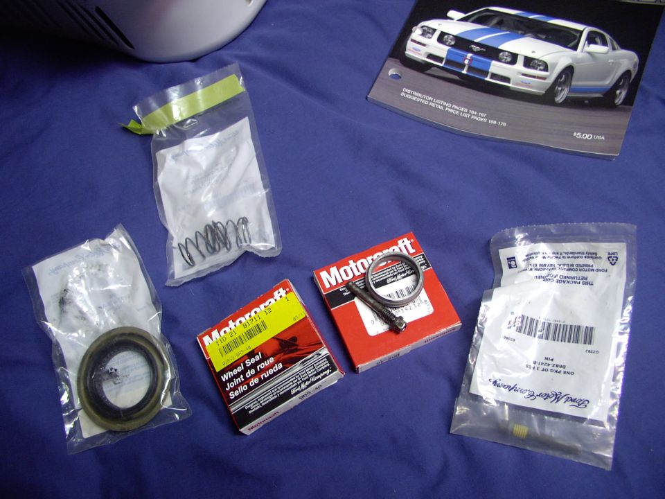 Pinion seal on the left (in bag), two outer axle seals in boxes, crush sleeve and pin lock bolt (old) and new one, with loctite in threads, in package below it