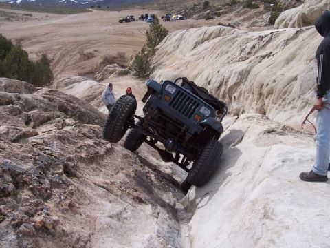 1989 Ford Bronco - A Jeep Wrangler navigates a challenging rocky terrain during an off-road excursion.