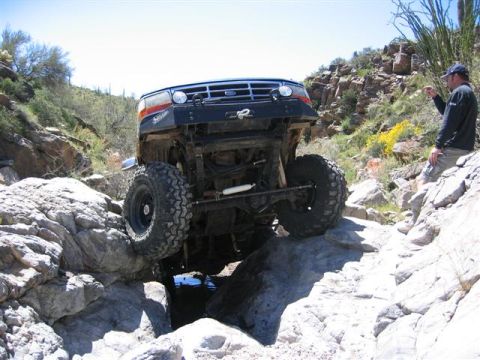 1994 Ford Bronco - Ford Bronco tackles a challenging rocky terrain during an off-road adventure.