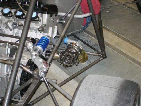 1985 Ford LTD Crown Victoria - Close-up view of a custom racing car's engine bay and suspension components.
