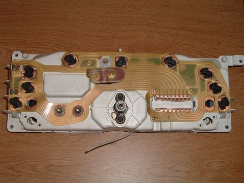 1989 Ford Crown Victoria LTD - The rear of a vehicle's instrument cluster circuit board is shown, with visible copper traces and electrical connectors.