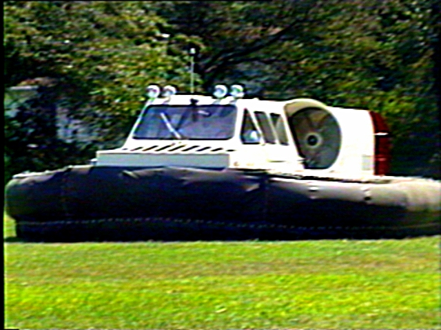 Hovercraft with large rear fan and inflatable skirt, seen from the side