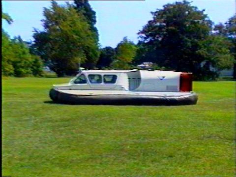 1972 Ford Bronco - A hovercraft sits on a lawn, with trees and a clear sky behind it.