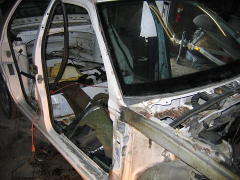 1989 Peugeot 405 - Interior view of a car undergoing dismantling, with doors open and interior components removed.