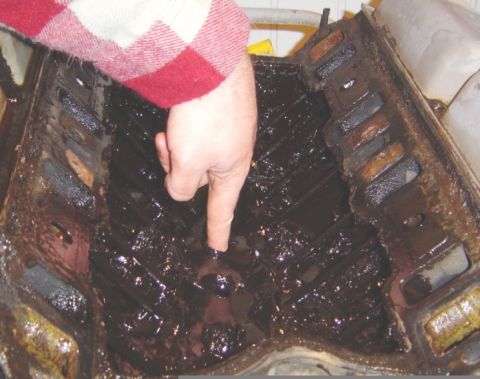 1986 Ford Bronco - Engine block filled with thick, dark sludge, indicating potential internal issues.