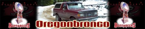 1996 Ford Bronco - Maroon Ford Bronco navigates a snowy, wooded road.