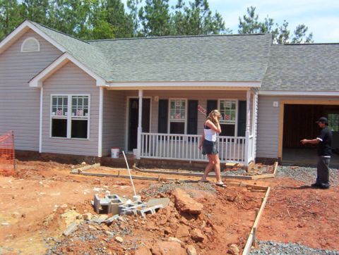 1986 Ford Bronco - A house under construction with two people on the property.