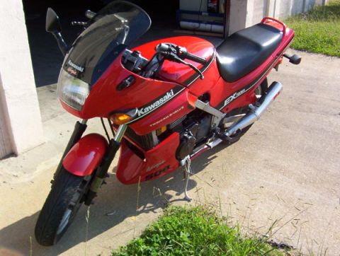 1986 Ford Bronco - A red Kawasaki Ninja EX500 motorcycle is parked on a concrete surface.