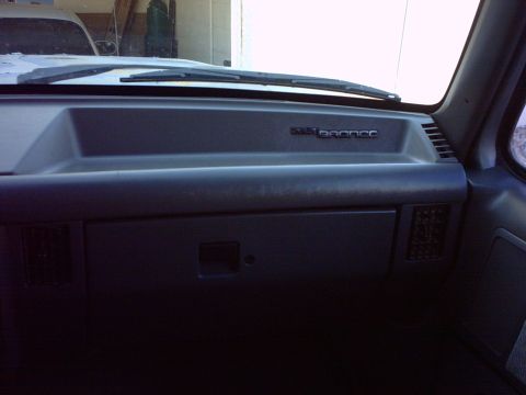 1990 Ford Bronco - The dashboard of a 1990 Ford Bronco shows the model name badge on the passenger side.