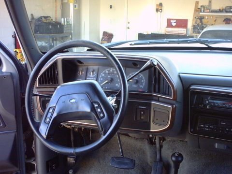 1990 Ford Bronco - Interior view of a 1990 Ford Bronco, focusing on the dashboard and steering wheel.