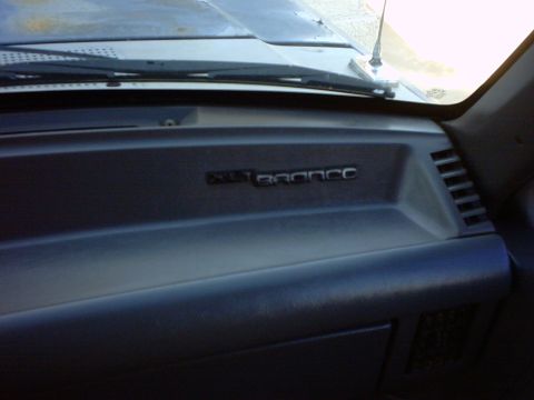 1990 Ford Bronco - The dashboard of a Ford Bronco shows the model name emblem.
