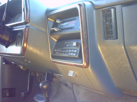 1990 Ford Bronco - Dashboard interior view showing dual radios and a floor-mounted gear shifter.