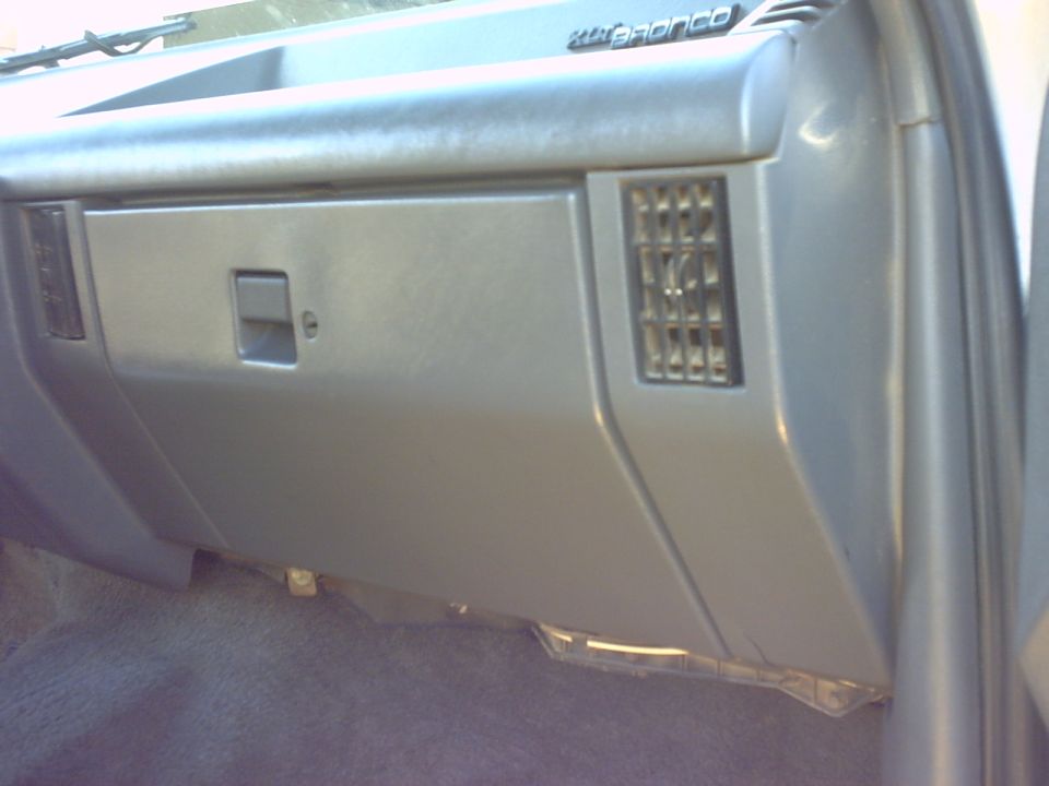 1990 Ford Bronco interior showing glove box and air vent