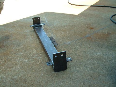1995 Ford Bronco - A fabricated metal bumper assembly with mounting brackets is shown on a concrete surface.