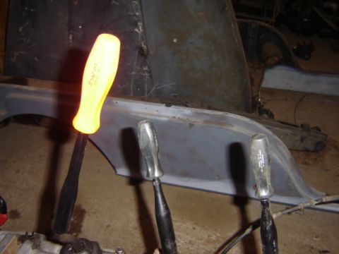 1992 Ford Bronco - Tools are positioned near the frame of a vehicle, possibly during a repair or restoration.