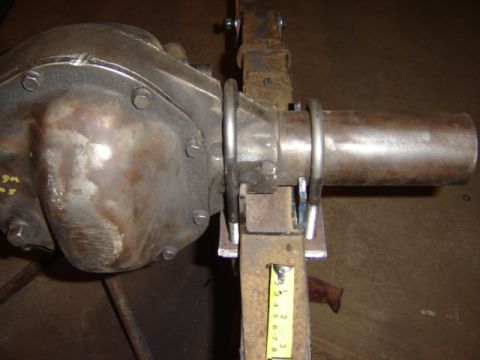 1992 Ford Bronco - Close-up of a rear axle differential assembly, showing U-bolts and a measuring tape for scale.