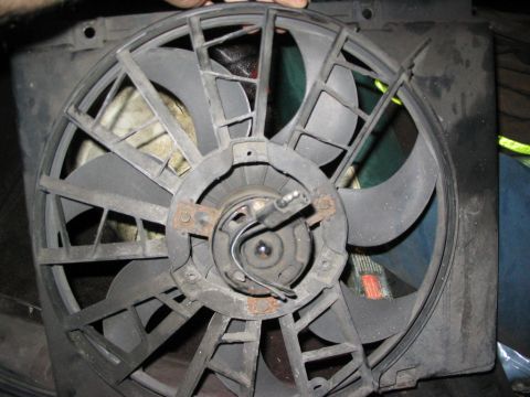 1986 Ford Bronco - A radiator fan assembly is shown, with visible rust on its motor mounting brackets.