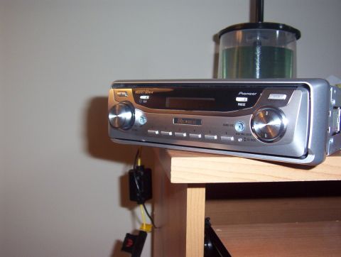 1997 Ford Probe - A Pioneer car stereo is shown with a stack of CDs in a case behind it.