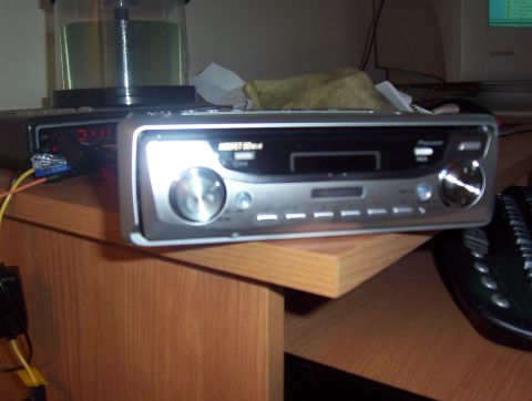 1997 Ford Probe - A car stereo is shown on a desk, with a computer monitor in the background.