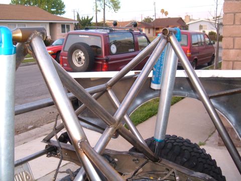 2002 Ford Ranger - Custom roll cage and suspension components are shown, with other vehicles in the background.