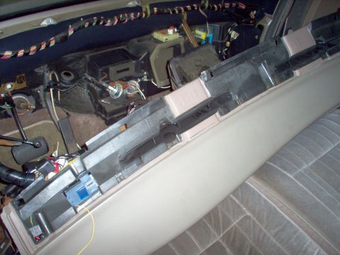 1994 Ford Crown Victoria - The interior of a car shows the dashboard removed, revealing exposed wiring and electronic components during a repair or modification.