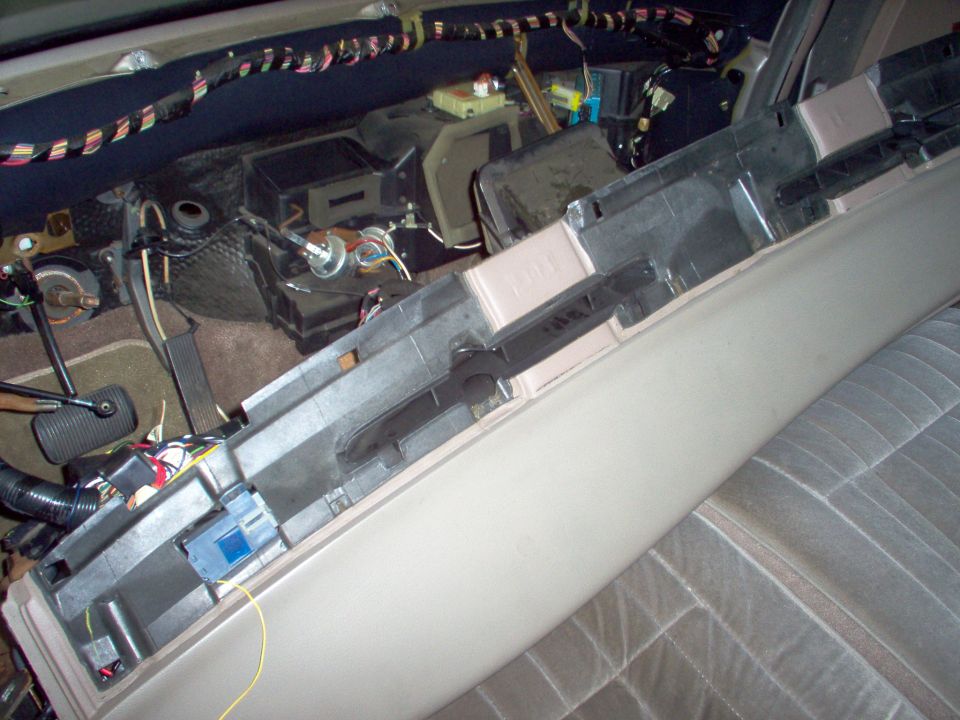 Partially disassembled dashboard showing HVAC ducts and wiring harnesses