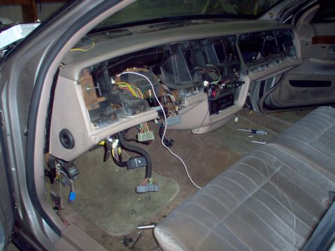 1994 Ford Crown Victoria - The interior of a 1994 Ford Crown Victoria shows a disassembled dashboard with exposed wiring and components.