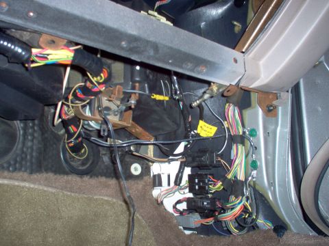 1994 Ford Crown Victoria - Close-up view of a complex vehicle interior wiring harness, showing numerous colorful wires and electrical connectors.