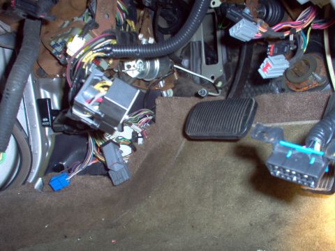 1994 Ford Crown Victoria - Close-up of a car's interior wiring and pedals, likely under the dashboard.