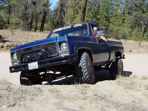 1979 Chevrolet C/K Pickup - This blue 1979 Chevrolet C/K Pickup is equipped with a bull bar and large off-road tires, ready for adventure.