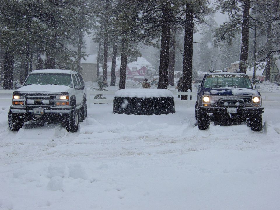 Blue pickup truck with "DREAM ON" on windshield, front view in snow