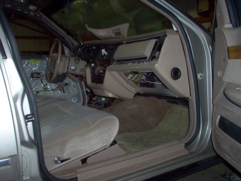 1994 Ford Crown Victoria - The interior of a 1992 Ford Crown Victoria is disassembled, revealing its internal wiring and components.