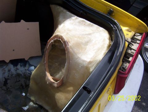 1994 Ford Probe - A custom fiberglass enclosure is being installed in the trunk of a yellow vehicle.