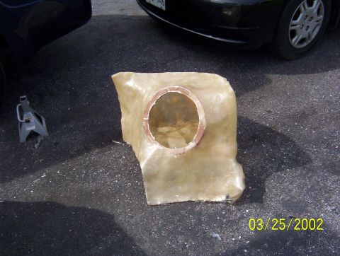 1994 Ford Probe - A custom fiberglass part sits on asphalt next to a car jack and a black vehicle.