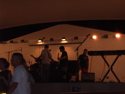 1988 Ford Bronco - Musicians perform live on stage with guitars and keyboards under bright lights.