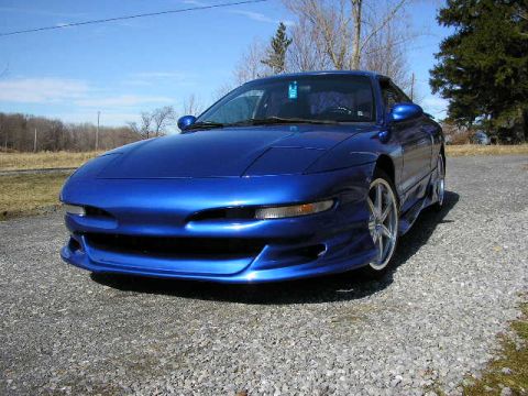 1994 Ford Probe - A blue 1994 Ford Probe is shown from a three-quarter front angle on a sunny day.
