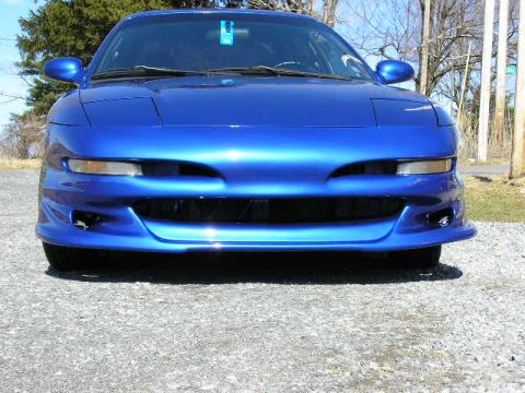 1994 Ford Probe - Front view of a blue 1994 Ford Probe, showing its distinctive headlights and grille.