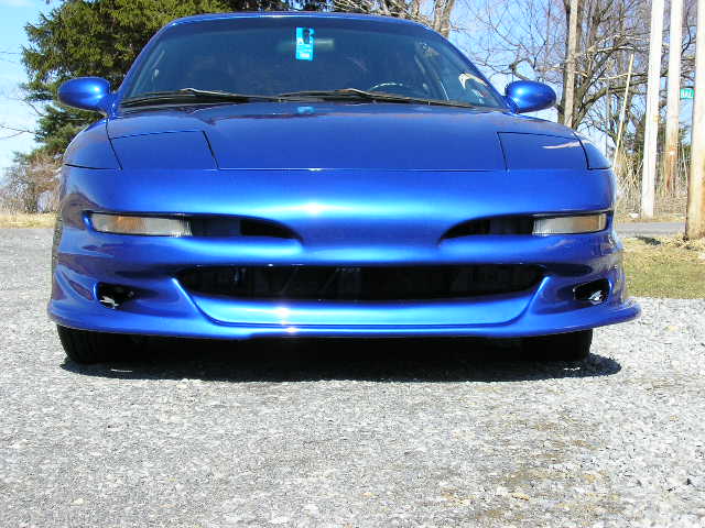 Front view of a blue 1994 Ford Probe with aftermarket body kit