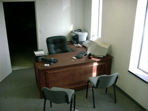 1999 Jeep Grand Cherokee - An office scene a desk with a computer monitor, keyboard, telephone, and two chairs.