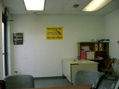 1999 Jeep Grand Cherokee - An office scene shows a desk, chairs, and a sign for a mulching service.