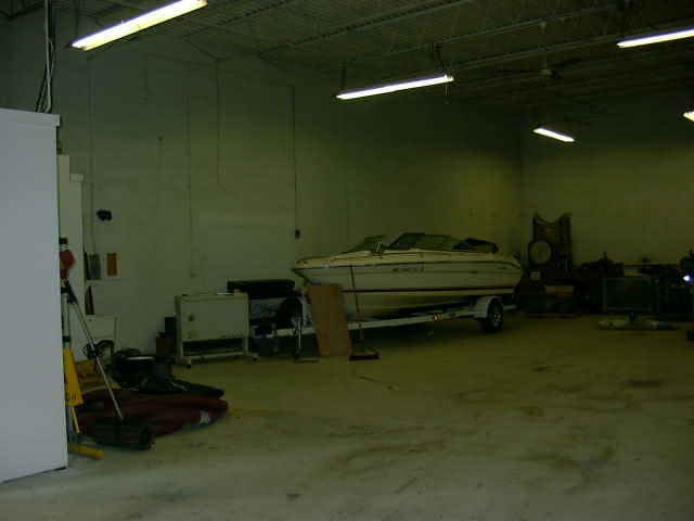 Boat on a trailer inside a warehouse, side view