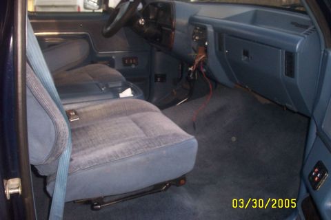 1979 Ford F-150 - The interior of a blue truck is shown, with a focus on the seats and dashboard area.